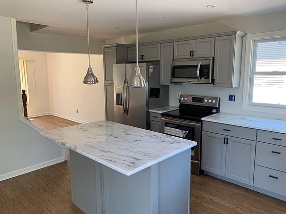 Recently installed kitchen and appliances with marble counters. Plenty of natural light