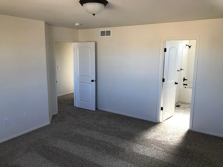 Primary bedroom with attached bathroom
