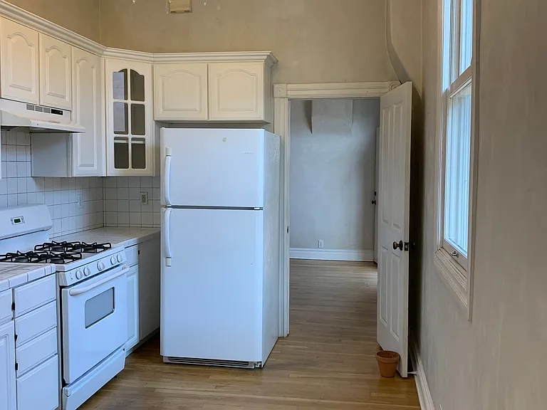 Another picture of the kitchen leads into the master bedroom_ The chandelier stays