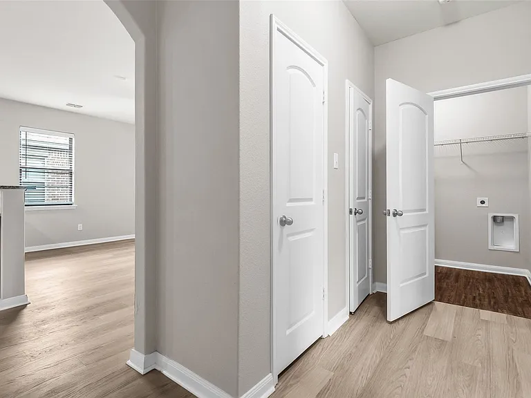 Hallway to additional bedrooms, hall closets, laundry and guest bath.