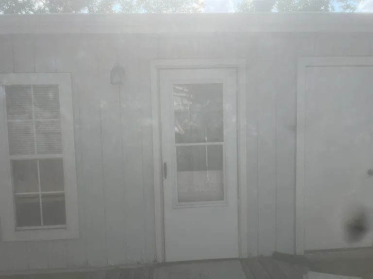 Back Porch Door in middle (attached storage doors on the right)
