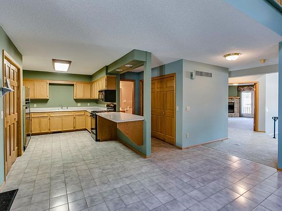 Huge kitchen with tons of counter space and storage.  Oversized pantry, black appliances and a solid surface counter top.  All Oak woodwork throughout home.