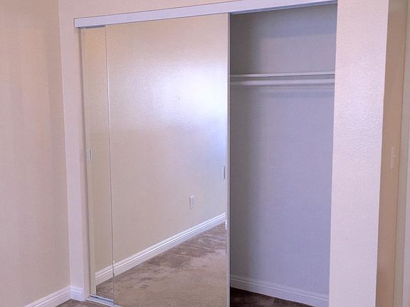 Rooms with mirror wardrobe closets and ceiling fans