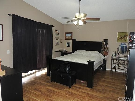Huge Master bedroom with laminated flooring.