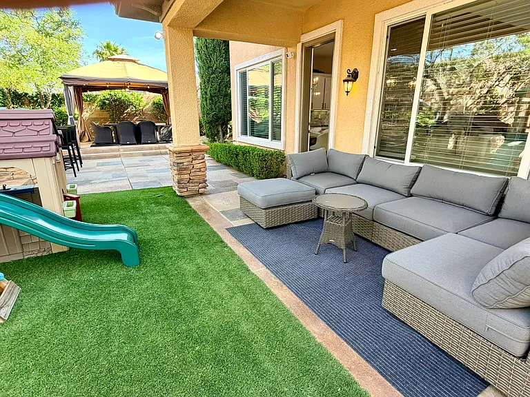 Outdoor covered seating area with turf/play area