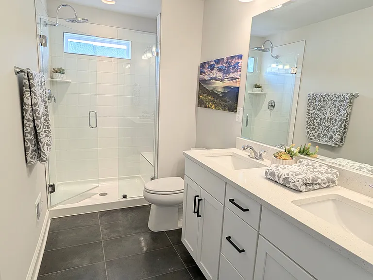 Ensuite, QUARTZ dual sink vanity, TILE-shower, window, rainfall shower head, glass doors, bench, floor grey tile.