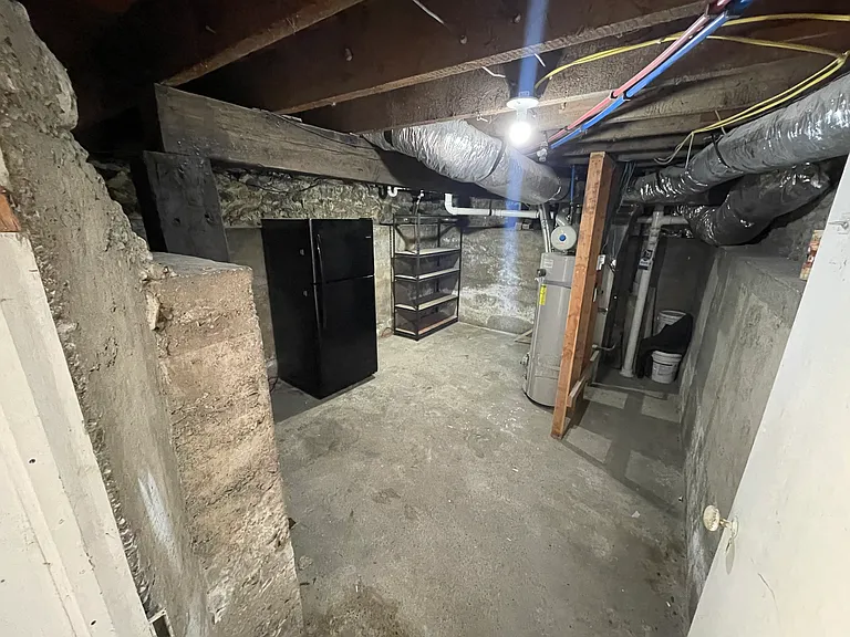 Basement storage space/mechanical room. Extra fridge and storage racks are available for use.