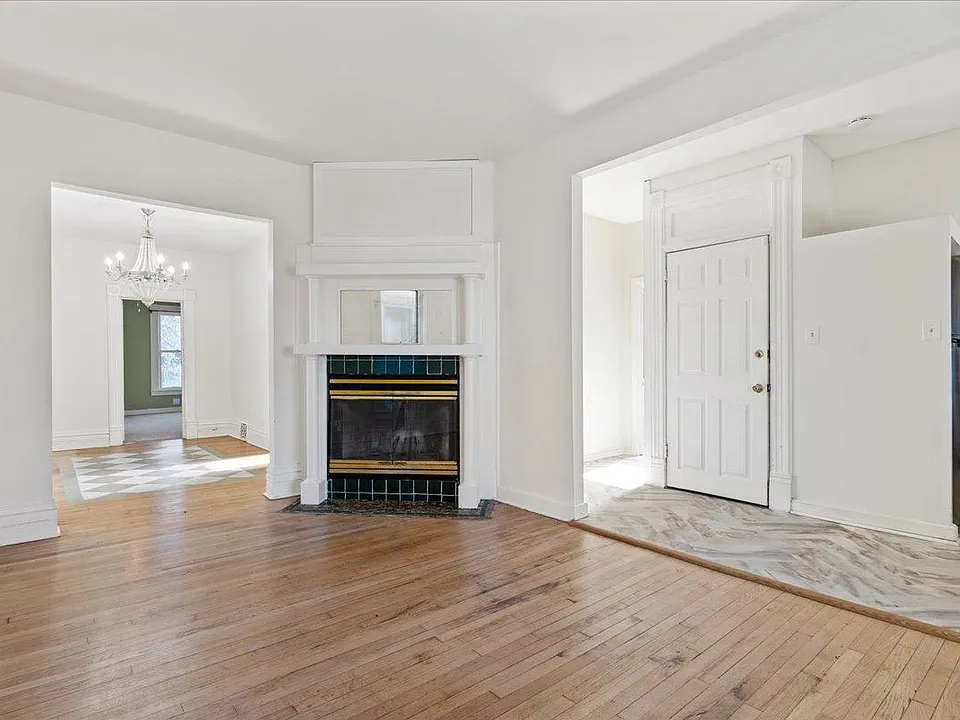 Bathroom to the left of front door, open concept living/dining featuring decorative fireplace.