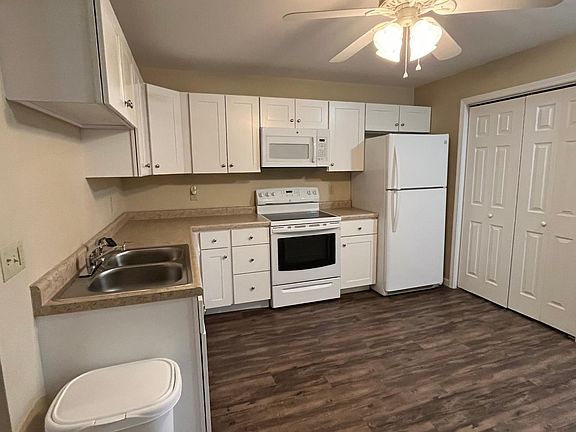 Kitchen with laundry area in unit.