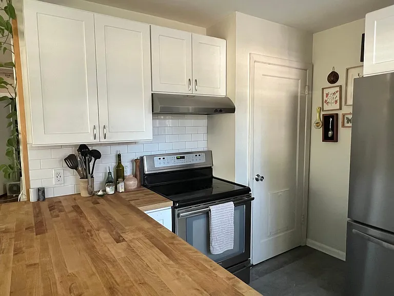 Butcher block countertops in kitchen and door down to basement