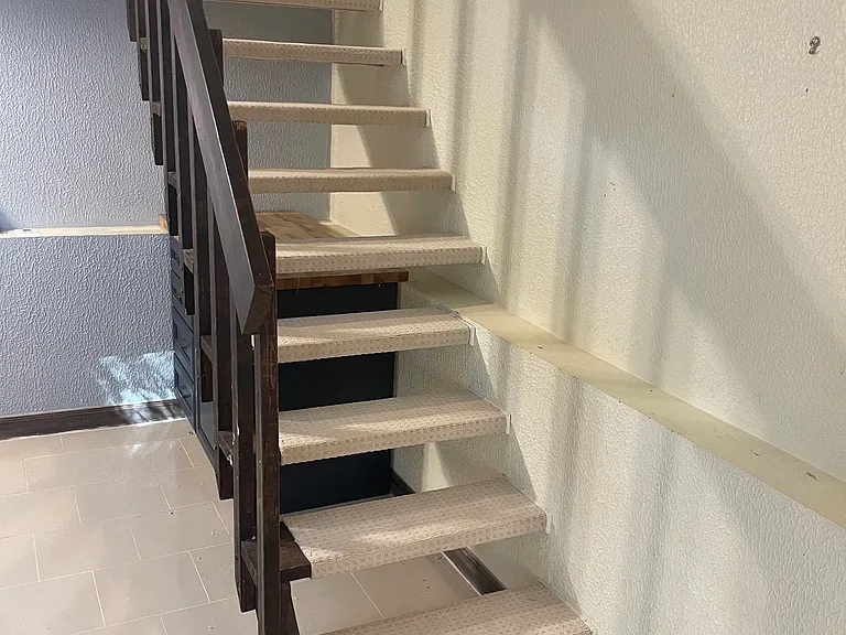 Stairs to the bedroom level.