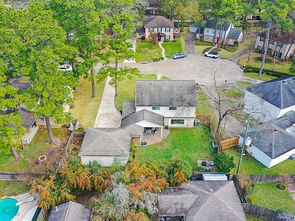 Another amazing aerial view from the back of the home toward the cul-de-sac shows where the home sits on this peaceful street. The long driveway widens near the garage to allow additional space for parking multiple cars!