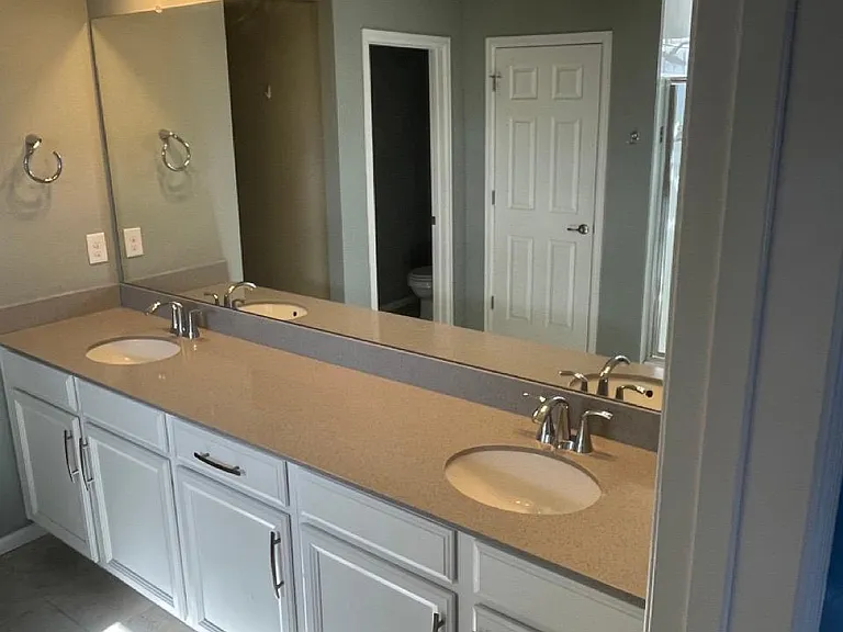 En-suite bathroom with shower and double sink