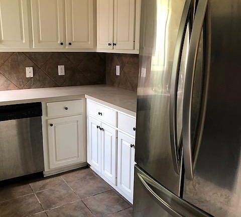 Side by side stainless refrigerator stays with property