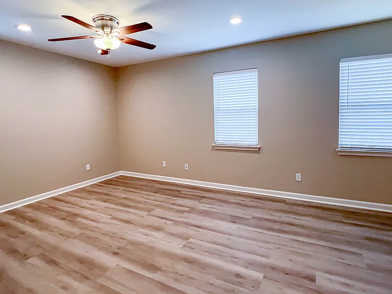Primary bedroom located just off the main living area and thoughtfully separated from the secondary bedrooms for added privacy.