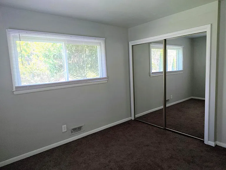 Bedroom 2 with mirrored closet doors