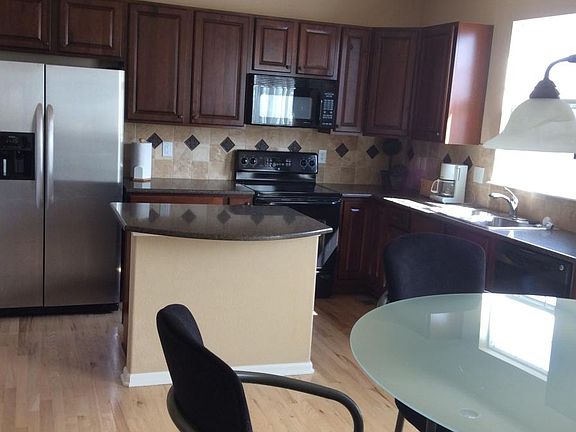Walnut cabs, granite counters, wood floors