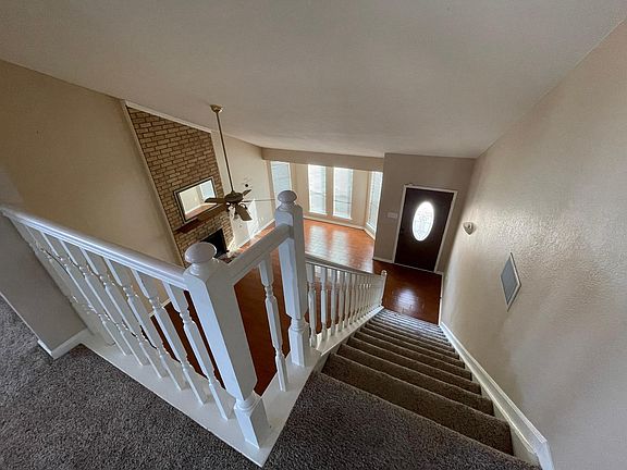 View of the living room and entry from the top of stairs.