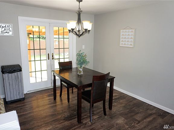 Close up of Dining Room & French Doors. Newer light fixture, white trim & doors.