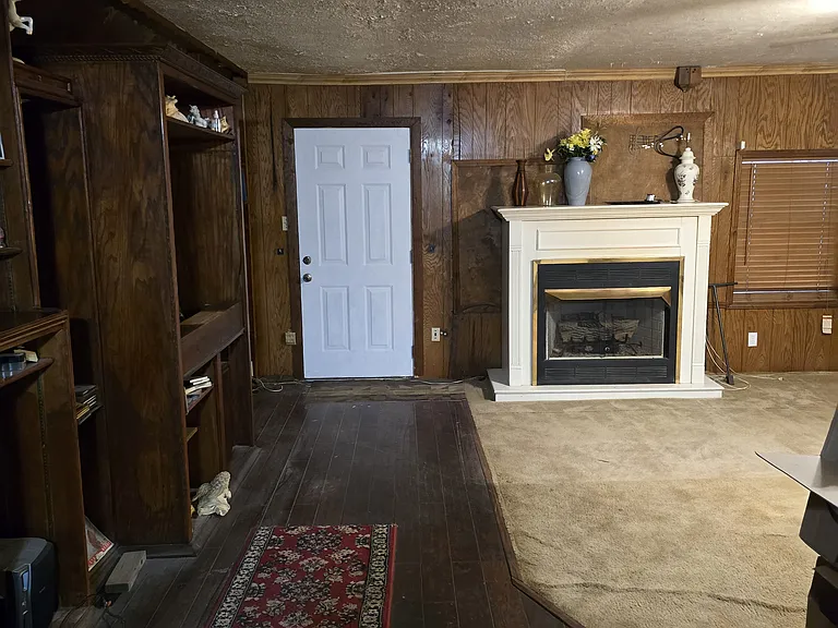 Second family room with built in entertainment center with book shelves and cabinets