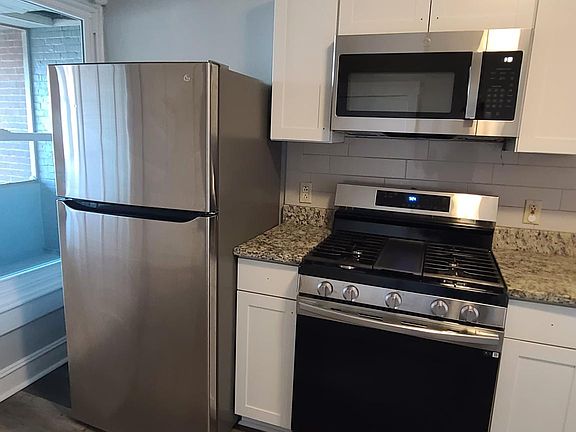 New kitchen cabinets with granite counter and stainless steel appliances