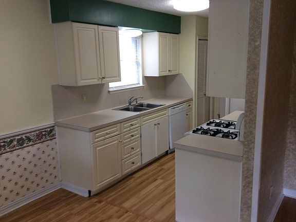 Kitchen. Deep stainless steel sink, gas stove, refrigerator with icemaker. Pantry on each side with new doors.