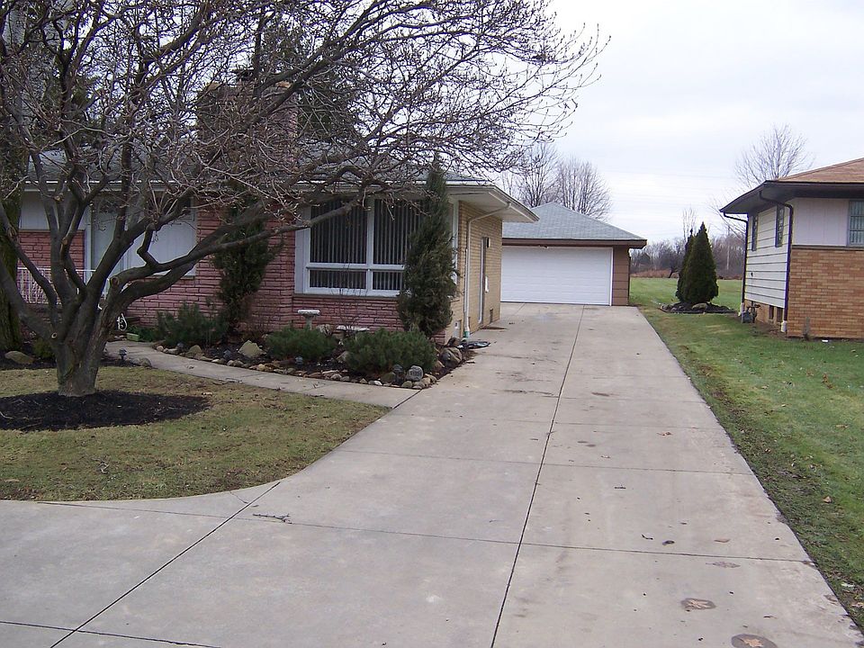 Brick ranch with extra cement for parking and storage in the back