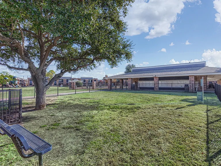 Beautifully landscaped community courtyard with enclosed bark park