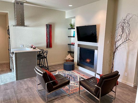 Gas fireplace and 55 inch TV comes with the rental. Quartz countertop for meals facing the view of the water.