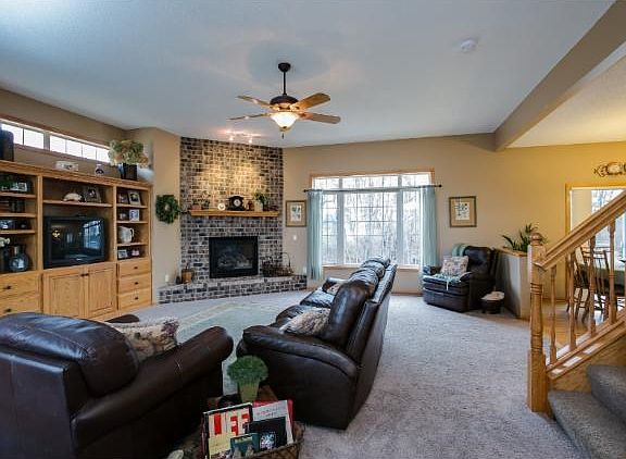 Main floor family room with 10' ceilings, custom built-in entertainment center, brick gas FP and private views to wooded backyard.