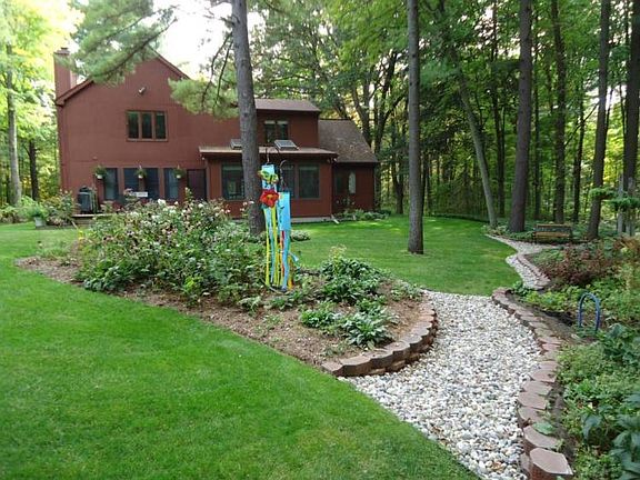 Look out over sweeping lawns, and stately trees on all sides.  This property has a nice blend of lawn, shrubs, plants, and trees.