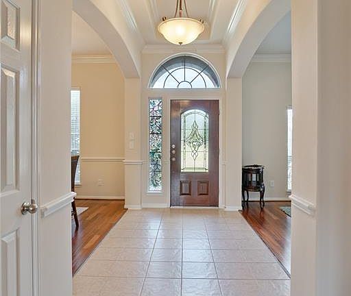 Large grand entry with high ceilings show how open the home is.