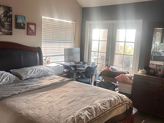 Master bedroom w/ French doors and ocean view