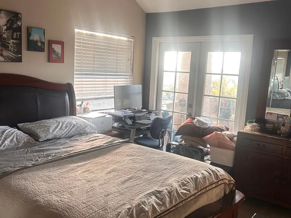 Master bedroom w/ French doors and ocean view