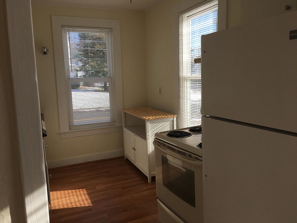 kitchen with stove and refrigerator and small eating area