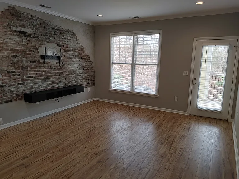 New hardwood floors installed throughout the kitchen and living room.