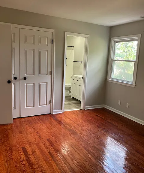 Primary bedroom viewing into primary bathroom