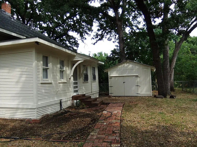 Rear view of house with storage shed