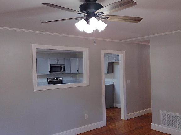Living room has cases opening so you can see into the kitchen and vice versa.