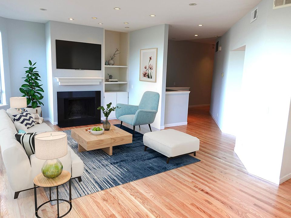 Living room with newly refinished wood floors, interior paint, recessed lighting, small balcony and downtown views.