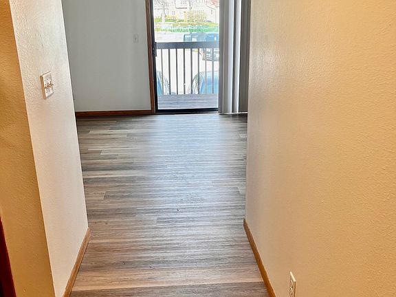 Entryway. Living room ahead, beds/bath to left
