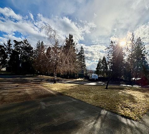 Looking out across the yard and driveway from the garage.