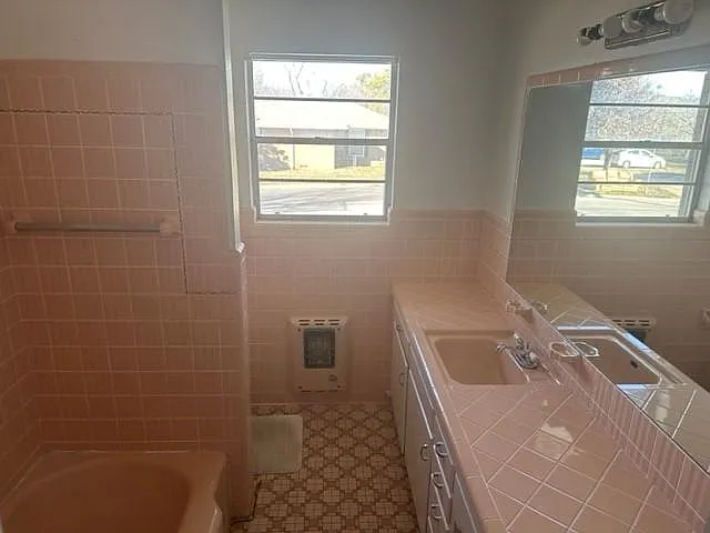 Spacious Hall Bath with Vintage tile and built in cabinets