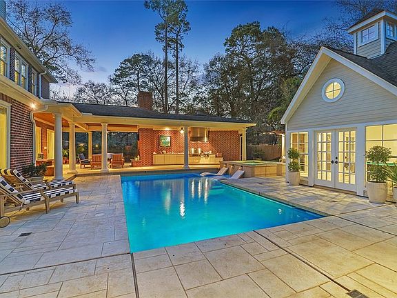 View of the covered outdoor seating area and custom outdoor kitchen.
