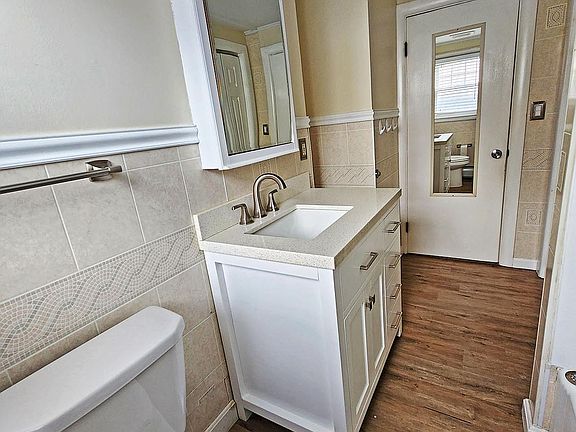 Large full bath with quartz counter top vanity