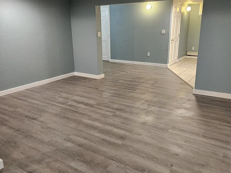 Living area and kitchen/dining space. Pantry and bathroom doors
