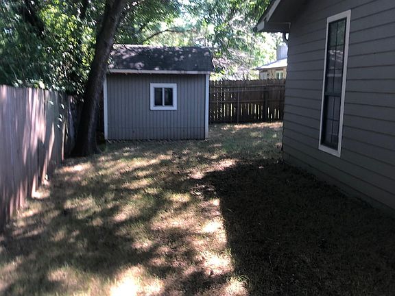 behind house with view of shed