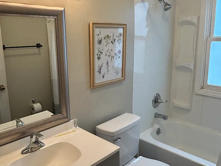 BATHROOM IS BRIGHT AND HAS BEEN UPDATED; GREY VANITY, ETC.