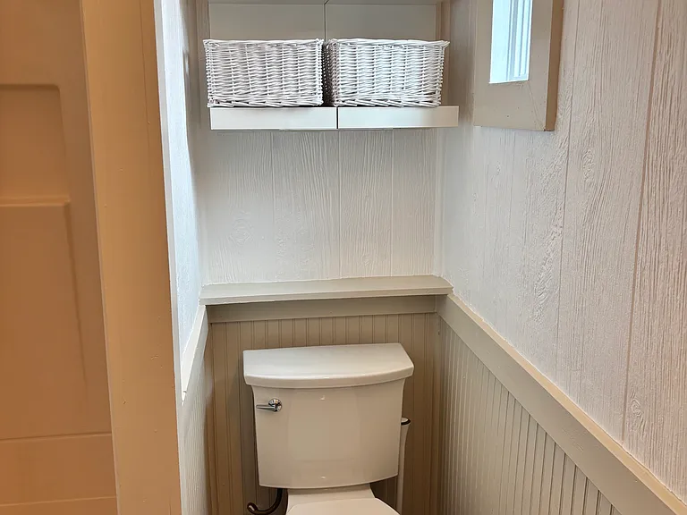 New Kohler toilet with piston flush technology and storage above.
