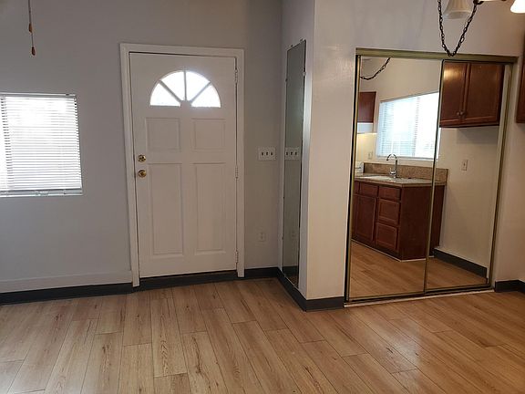 NEWER WOOD GRAIN TILE THOUGHTOUT THE HOUSE. IN THE CLOSET DOOR YOU SEE THE KITCHEN AREA